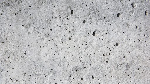 Coating voids and pores in a concrete floor.