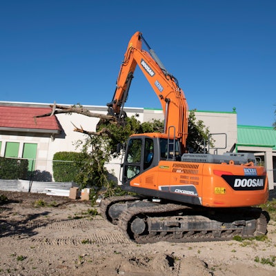 Several trees along the edge of the property needed to be removed. The excavator was paired with a bucket and thumb to help with the task.