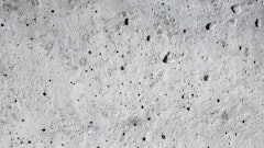 Coating voids and pores in a concrete floor.
