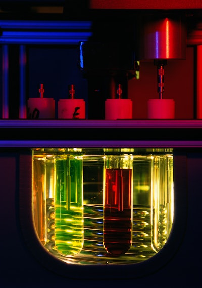 Oil viscosity is being tested in a lubricant lab.