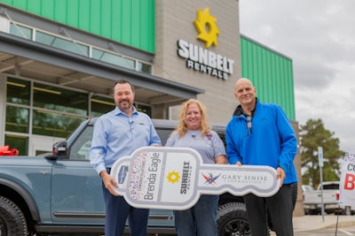 John Washburn, executive vice president at Sunbelt Rentals, and Craig Cannon, national account manager with Ford, present Brenda Eagle, Bordentown, NJ, with the key to her 2021 fully loaded, first edition Ford Bronco.