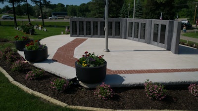 The completed Veteran’s Memorial contrasts the starkness of concrete and polished granite with the vitality of landscape in a solemn, reflective setting.