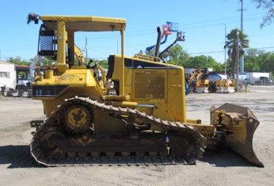 This is a Caterpillar machine with OROPS, a high-track configuration and a C-frame mounted blade.