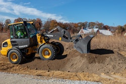 The L25 Electric compact wheel loader is being used to haul and lay down gravel for a wheelchair-accessible half-mile trail around a pond and to clear brush.