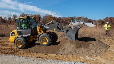 The L25 Electric compact wheel loader is being used to haul and lay down gravel for a wheelchair-accessible half-mile trail around a pond and to clear brush.