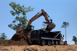 Case 300 excavators fitted with Werk-Brau 54-in. heavy-duty buckets cleared any remaining trees, grubbing them out along with the stumps and root balls left from the logging process.