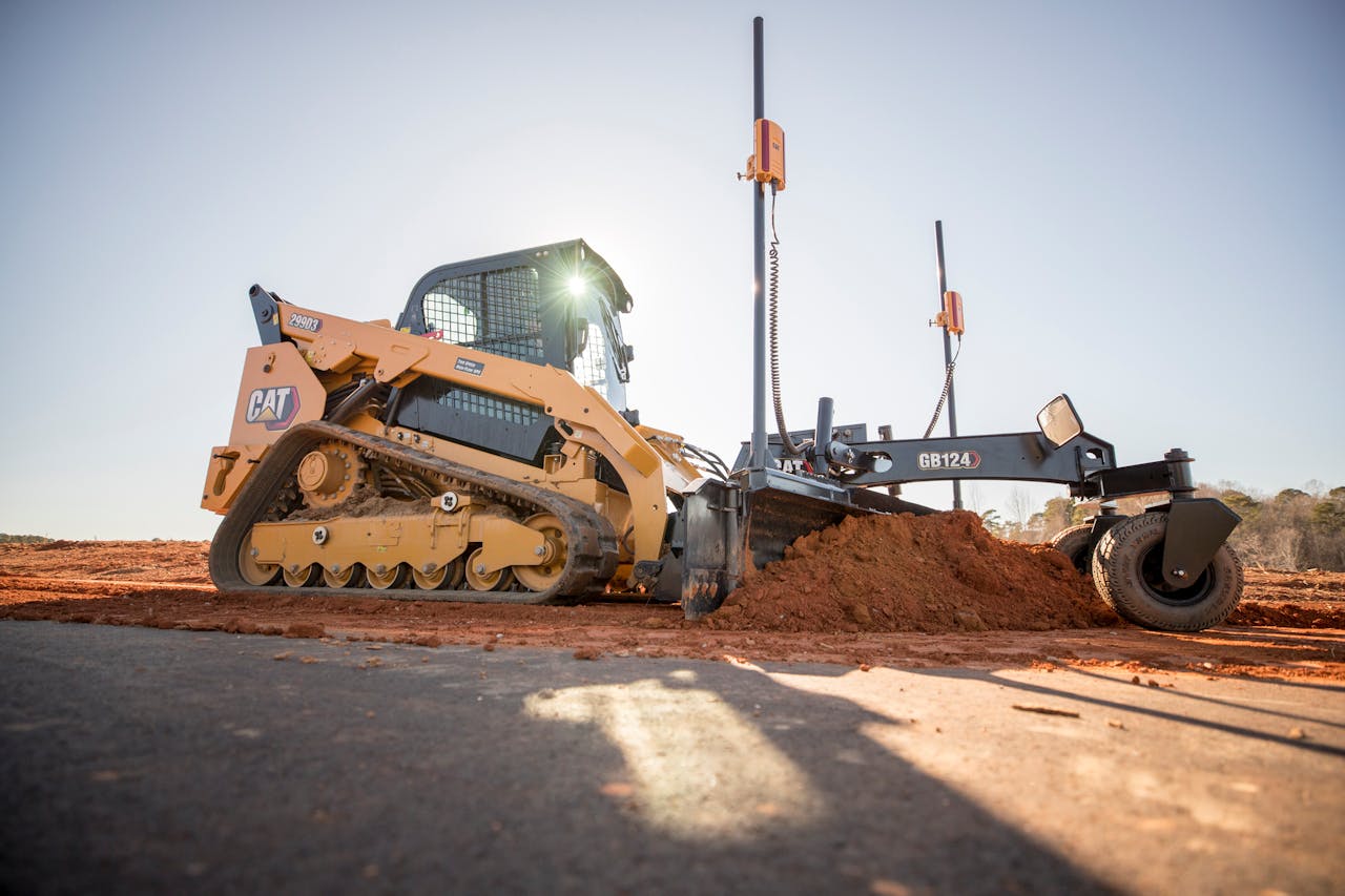 Sensors and processing power mounted on the Cat GB124 Smart Grader allow the attachment to interface with the loader and switch the loader joysticks to control the moldboard, with automation features like those found on full-sized graders.