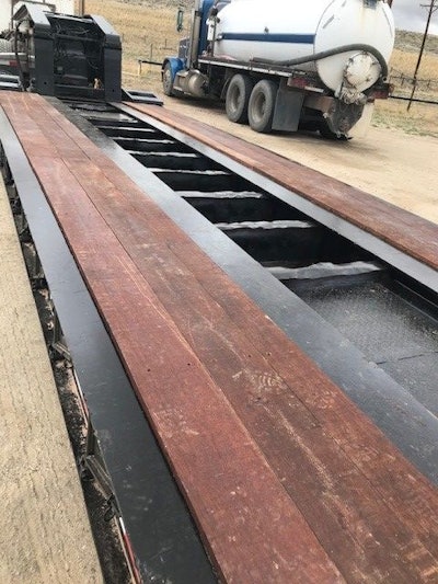 AFTER: Genuine Apitong/Keruing boards were cut then stained with the Apitong Oil and screwed down onto the lowboy using the installation tools supplied by TrailerDecking.com.