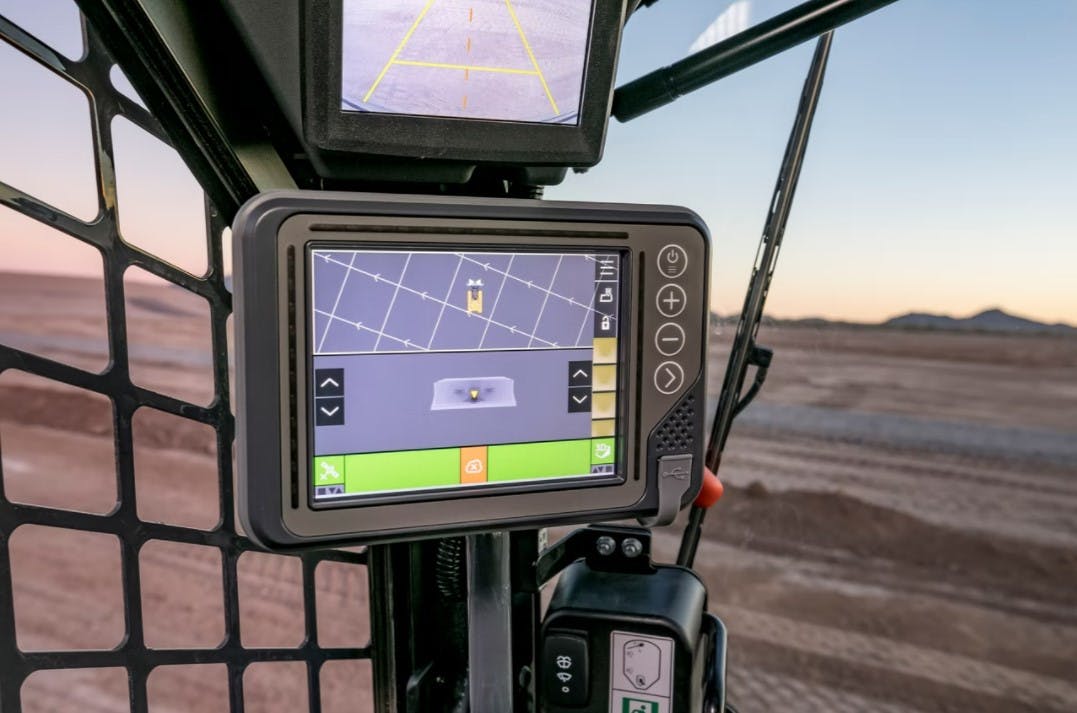 Digital controls on a PAT dozer blade attachment allow grade-indicate displays like this one in John Deere's 333G SmartGrade compact track loader cab.
