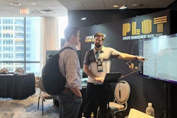 Jobsite logistics startup Plot exhibits at Advancing Construction Technology 2022. Here, Founder and CEO Chris Callen connects with an attendee.
