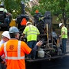 A crew on a parking lot project in Indianapolis prepares to lay asphalt that includes Invigorate Additive.