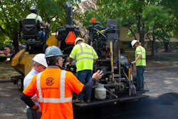 A crew on a parking lot project in Indianapolis prepares to lay asphalt that includes Invigorate Additive.