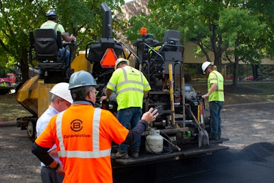 A crew on a parking lot project in Indianapolis prepares to lay asphalt that includes Invigorate Additive.