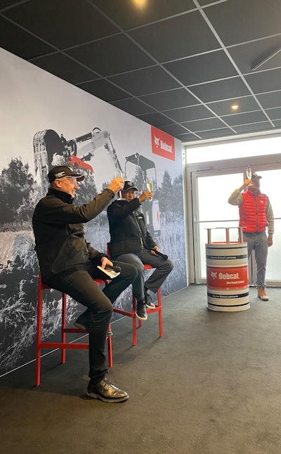 The Bobcat team, including Doosan Bobcat CEO Scott Park (center), raised glasses of prosecco to cheers the unveiling of Bobcat Company's new E19e excavator at a bauma 2022 press conference in Munich, Germany, on Monday, Oct. 24. Prost!