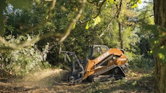 The CASE TV620B tackles a mulching task on soft ground in a heavily wooded area.