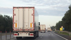 semi trailer truck driving down road