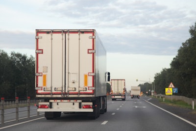 semi trailer truck driving down road