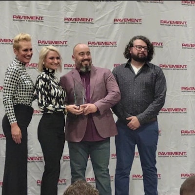 Amy Schwandt and Brandon Noel presenting Kristofer Love with his award for Seal and Stripe Large Job.