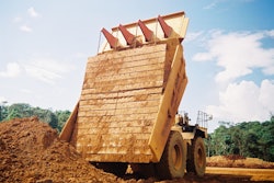 Carryback works against efficiency by reducing payload in the haul truck as residual material is left sticking to the sides and bottom of the truck, decreasing hauling capacity for subsequent loads.