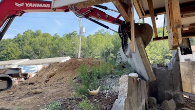A 21,550-pound Yanmar SV100 did most of the heavy lifting from the outside, removing large sections of the foundation wall and breaking them down for disposal.
