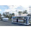 The skid infrastructure combines a 60kW propane generator with wind and solar power to create a microgrid that allows fleets to implement a drop-in charging solution.