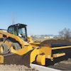 The accessory extends to the left or right of the FH-R and dispenses material over the curb to backfill with dirt or aggregate.