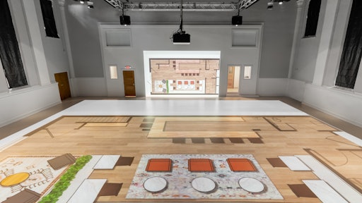 The company utilizes a multifaceted projection approach, displaying building plans on the floor as well as the adjacent wall, providing elevation readings such as countertops, windows and built-in bookshelf heights.