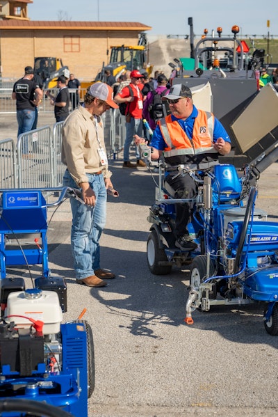 Graco demoing their traditional and electric machines side-by-side at the first PAVE/X.
