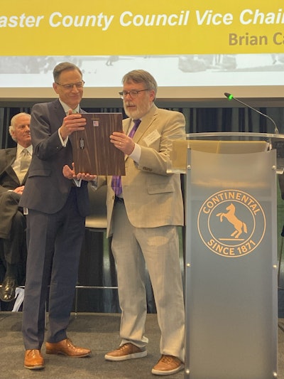 Carnes shares a proclamation with Etzel.