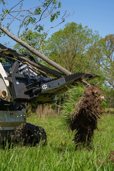 The attachment features dual 3.5- x 4-in. bore cylinders with a clamping force of 29,000 lbs., allowing removal of shrubs and trees along with their roots to prevent regrowth.