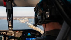 A Maryland Natural Resources Police officer conducts an overflight assessment of the M/V Dali, a 948-foot Singapore-flagged container ship, and Francis Scott Key Bridge in the Patapsco River in Baltimore, Md.