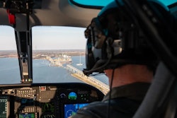 A Maryland Natural Resources Police officer conducts an overflight assessment of the M/V Dali, a 948-foot Singapore-flagged container ship, and Francis Scott Key Bridge in the Patapsco River in Baltimore, Md.