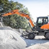 The DX100W-7 is equipped with steering, power and work modes to help operators customize their performance to move and work within confined spaces.