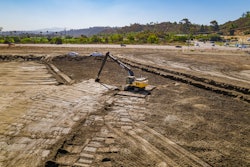 The operator uses an excavator with grade control to complete delicate earthmoving work at the San Dieguito Lagoon project.