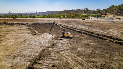The operator uses an excavator with grade control to complete delicate earthmoving work at the San Dieguito Lagoon project.