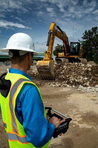 An operator controls an excavator using a belly box.