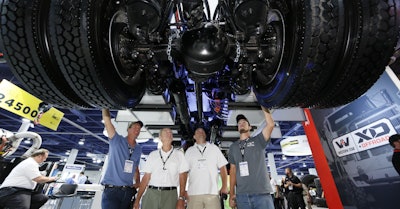 Attendees examine equipment up close on the show floor.