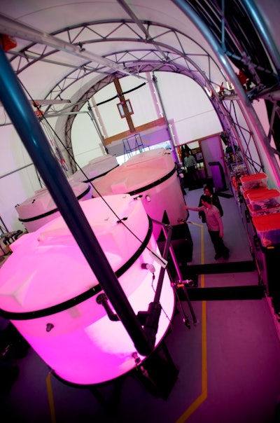 Light-filled tanks grow algae that consume CO2. This algae can be harvested and used as biofuel.