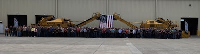 The company's employees gathered for a group photo at the event.