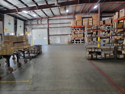 The materials area after implementing 'The Toyota Way,' taken spring of 2024. Shows the organization and cleanliness when aligning ordering policies to customer orders, and maintaining controls of materials so bulk materials are available in the warehouse, and the assembly lines only receive what is needed, versus the previous method of storing bulk materials in all locations, thus increasing total inventory.