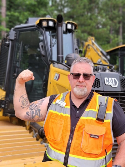 Michael Bastin, a Caterpillar employees, has a Cat-inspired tattoo.