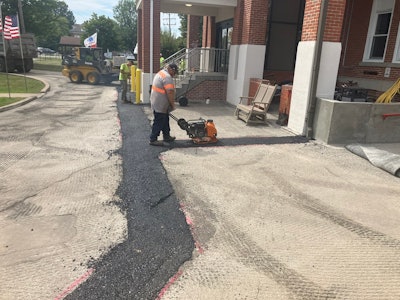 Pave Care employee Joe Dillaman (walk behind compactor), and Christian Shaffer (hand tamper) at a Paving project for Eire Veterans Home.