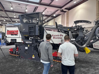 The American Pavement Specialists / Raised On Blacktop branded Wirtgen W 150 Fi on the PAVE/X showroom floor.