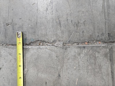 Joint edge spalling occurs when the joint filler is no longer protecting the joint edges and by rocking joints associated with slab curling that exposes edges to wheel impacts.