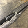 Concrete joint filler improperly filled over a backer rod.