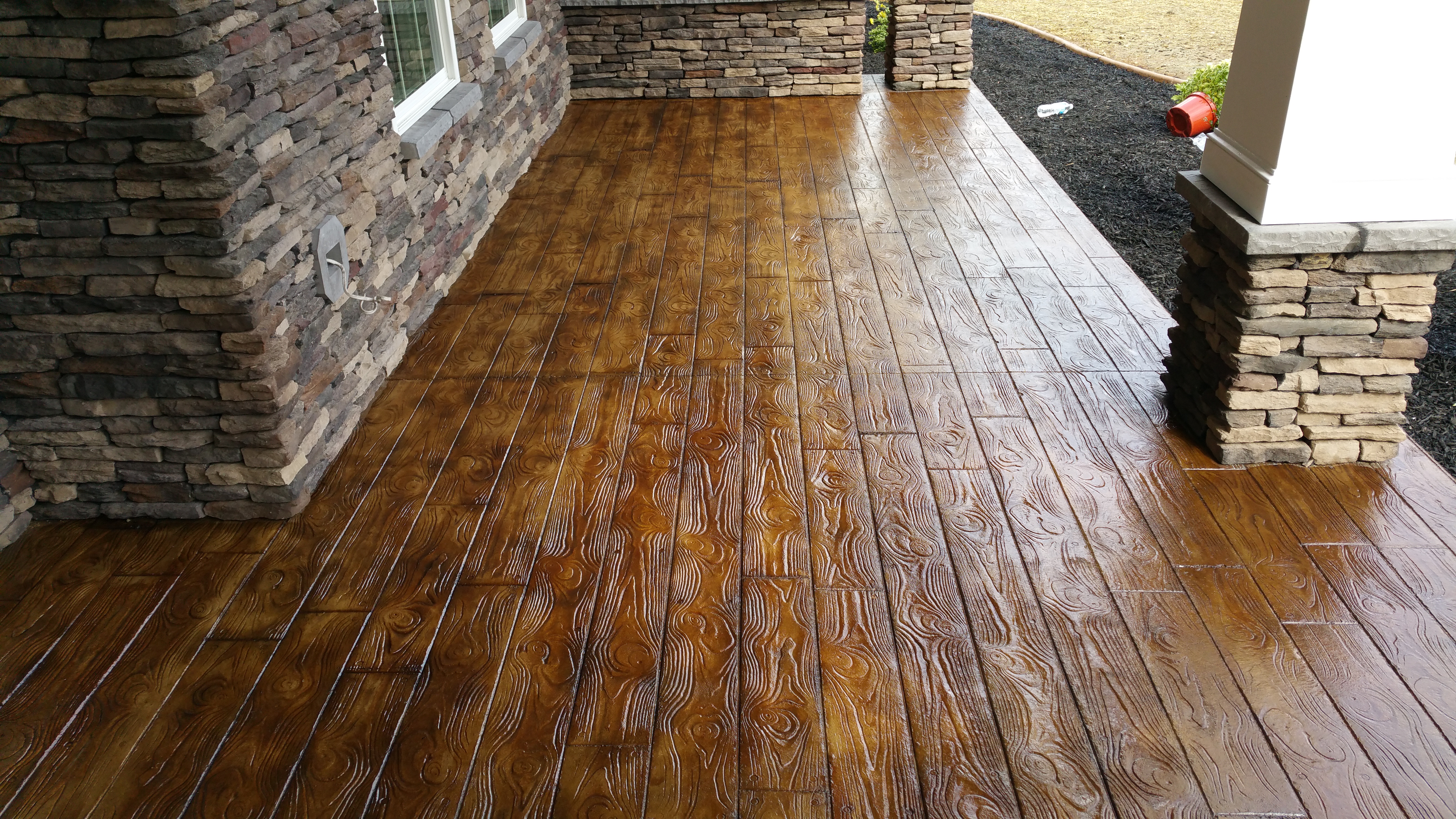 Stamped concrete mimicking natural wood delivers the look of timber with the durability of concrete.