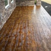 Stamped concrete mimicking natural wood delivers the look of timber with the durability of concrete.
