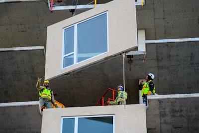 Unitized facade systems, such as this prefabricated panel, already include windows and insulation, reducing trade overlap, improving efficiency, and simplifying installation.