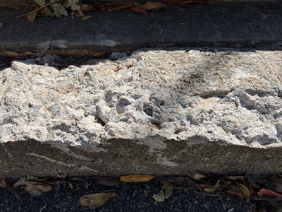 Concrete step with delamination removed, ready for repair.