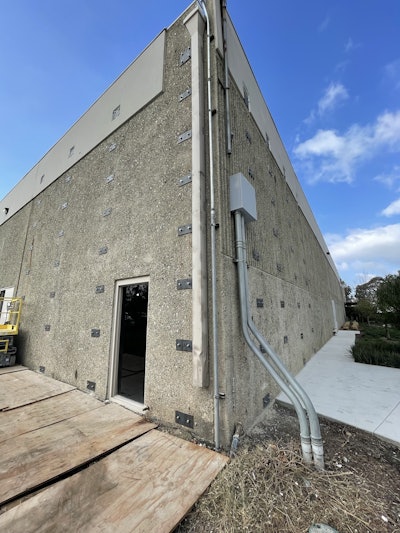 Structural repair to a tilt-up building using lateral structural framing reinforcement and structural steel vertical and lateral reinforcement systems.